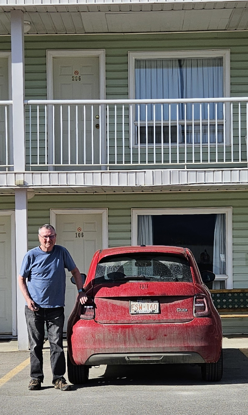 Small red car at motel